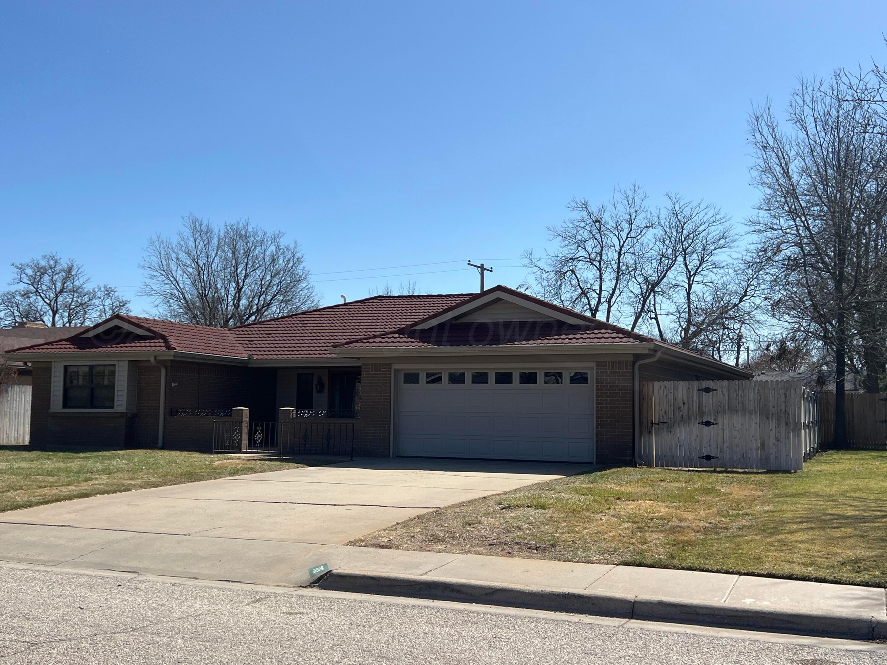 7115 Gainsborough Road Amarillo, TX 79106 - Photo 3 of 81 a front view of a house with a yard and garage