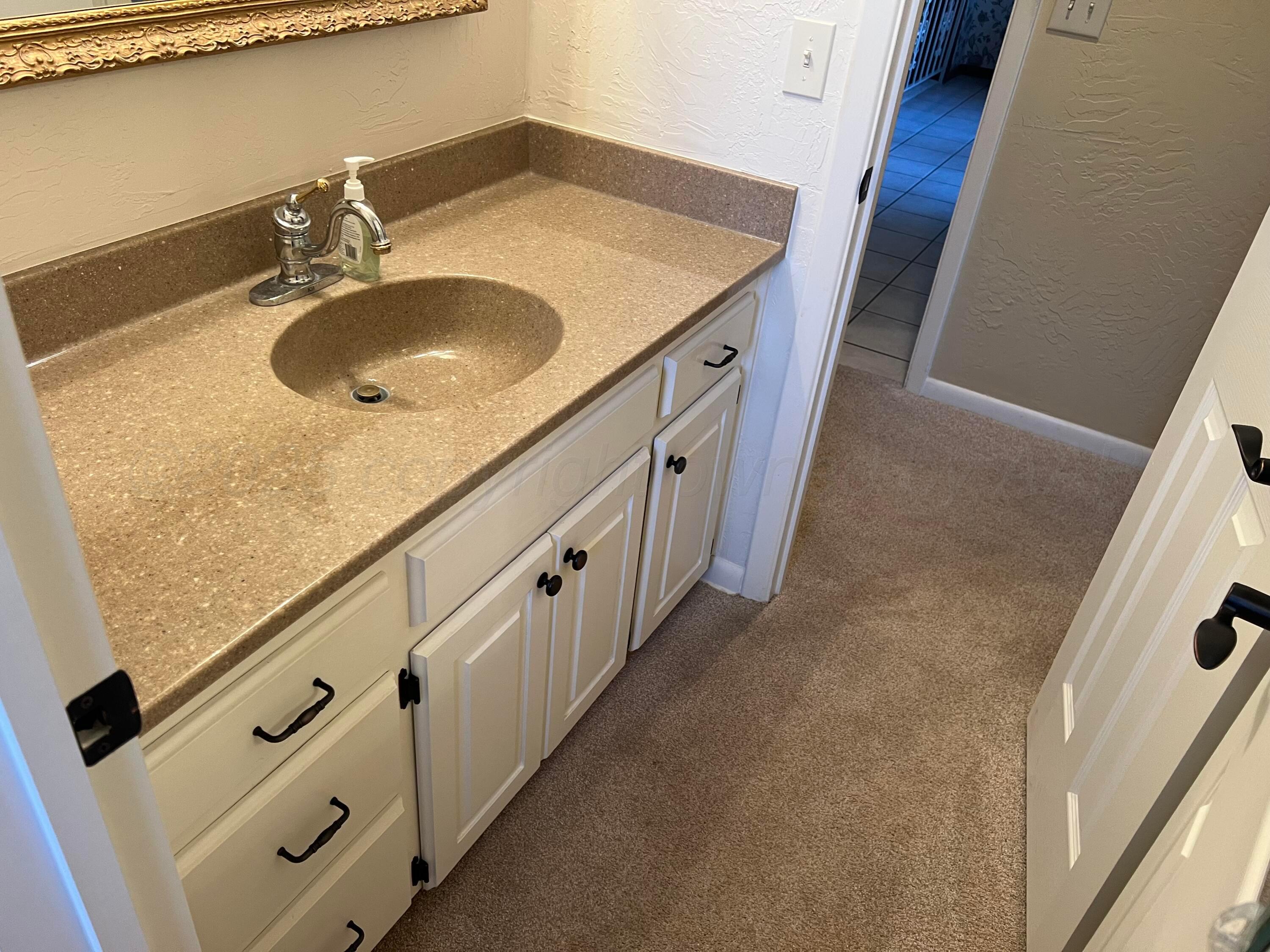 7115 Gainsborough Road Amarillo, TX 79106 - Photo 34 of 81 a bathroom with washing machine and sink