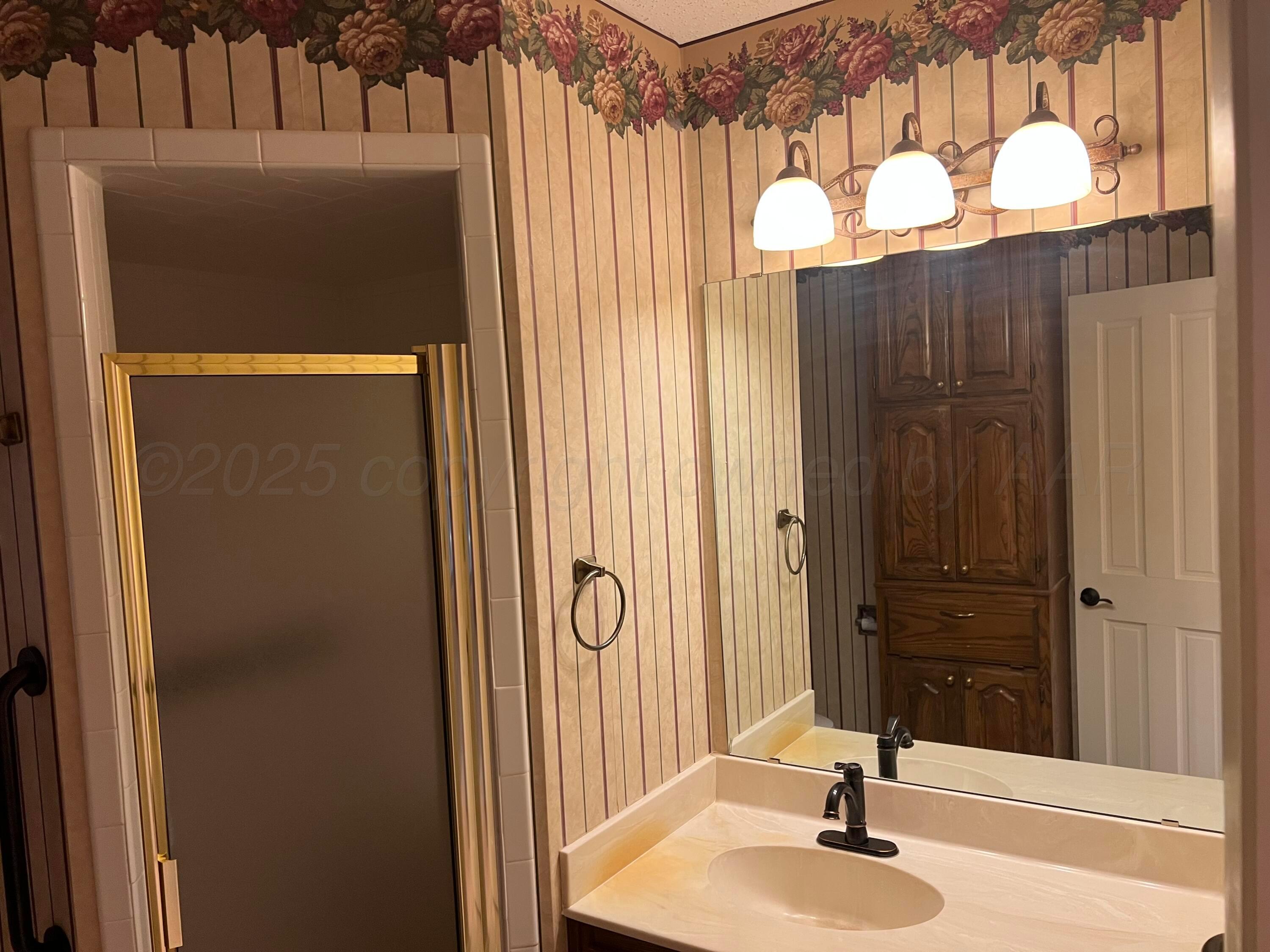 7115 Gainsborough Road Amarillo, TX 79106 - Photo 53 of 81 a bathroom with a sink and a mirror