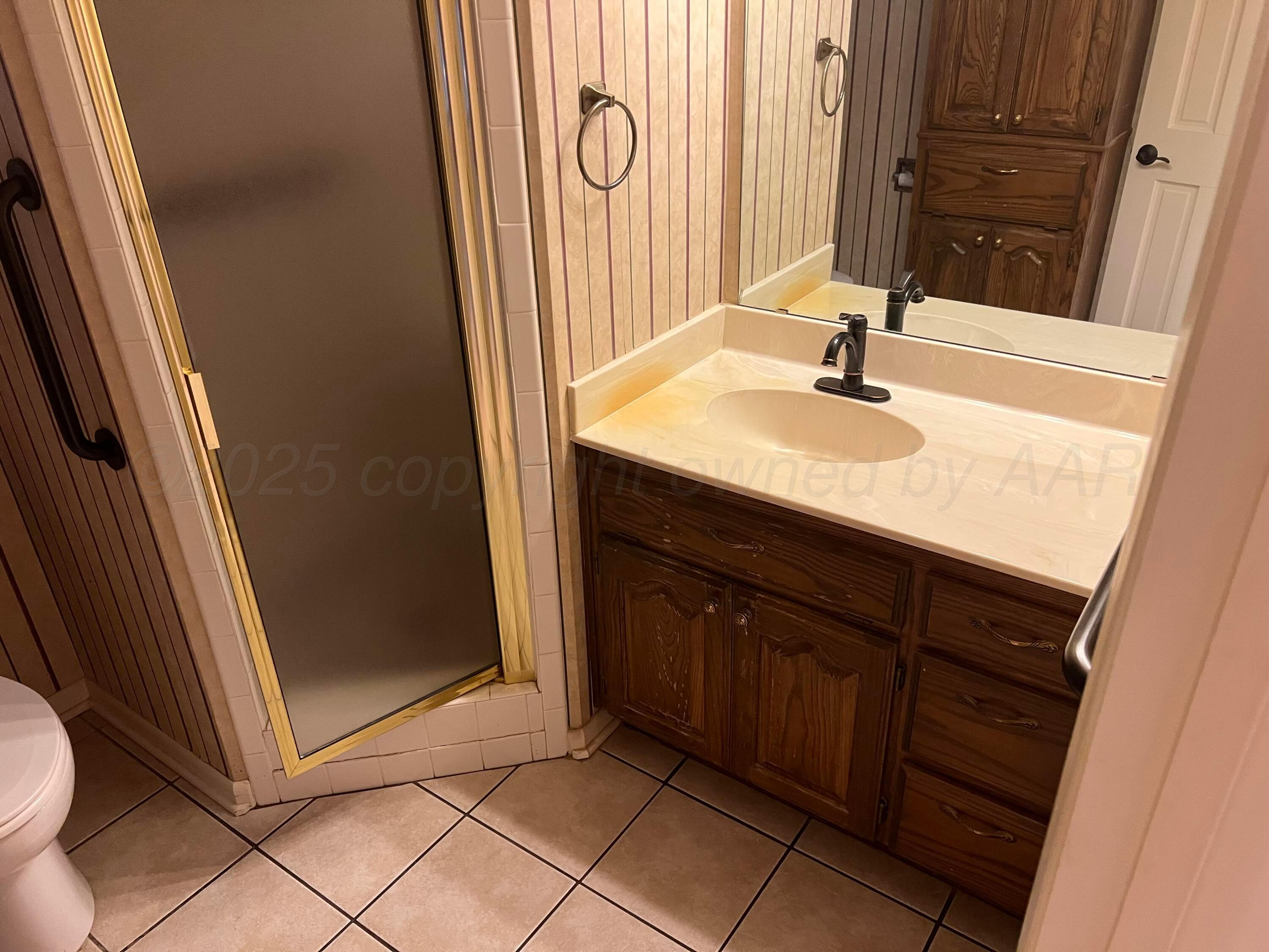 7115 Gainsborough Road Amarillo, TX 79106 - Photo 55 of 81 a bathroom with a sink a mirror and a shower