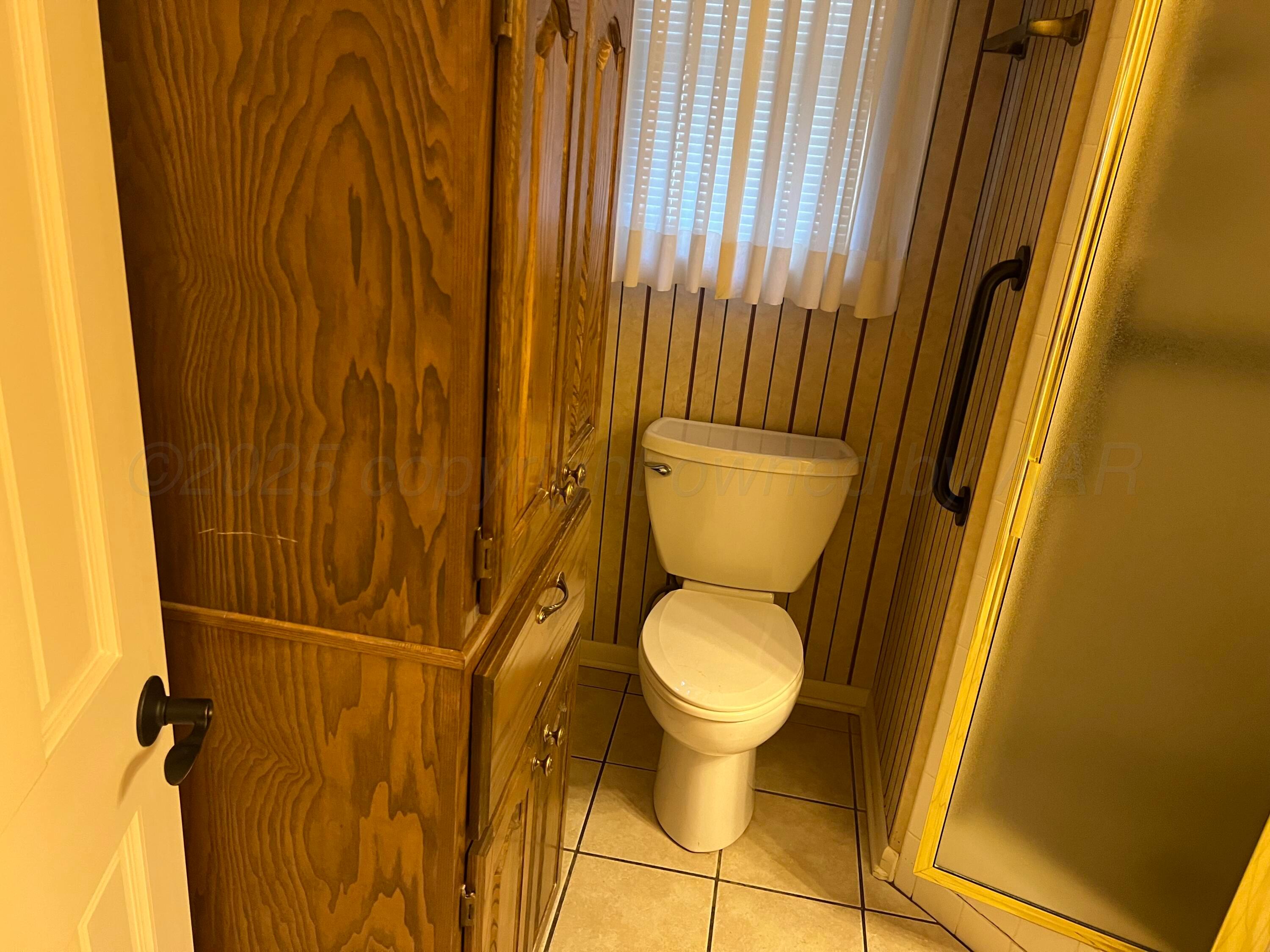 7115 Gainsborough Road Amarillo, TX 79106 - Photo 56 of 81 a bathroom with a toilet and a shower