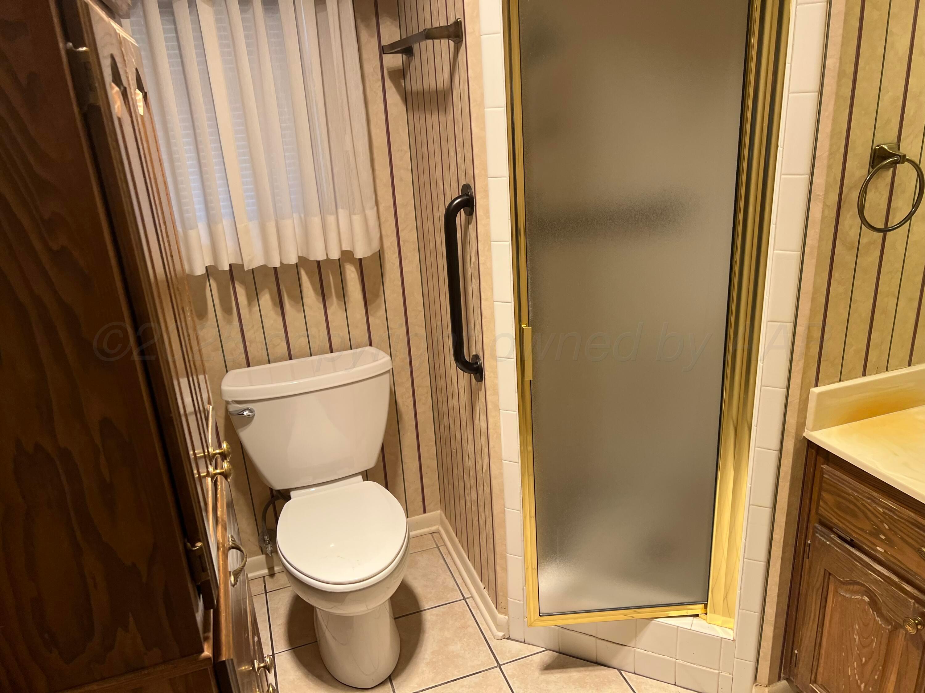 7115 Gainsborough Road Amarillo, TX 79106 - Photo 58 of 81 a white toilet sitting next to a bathroom sink