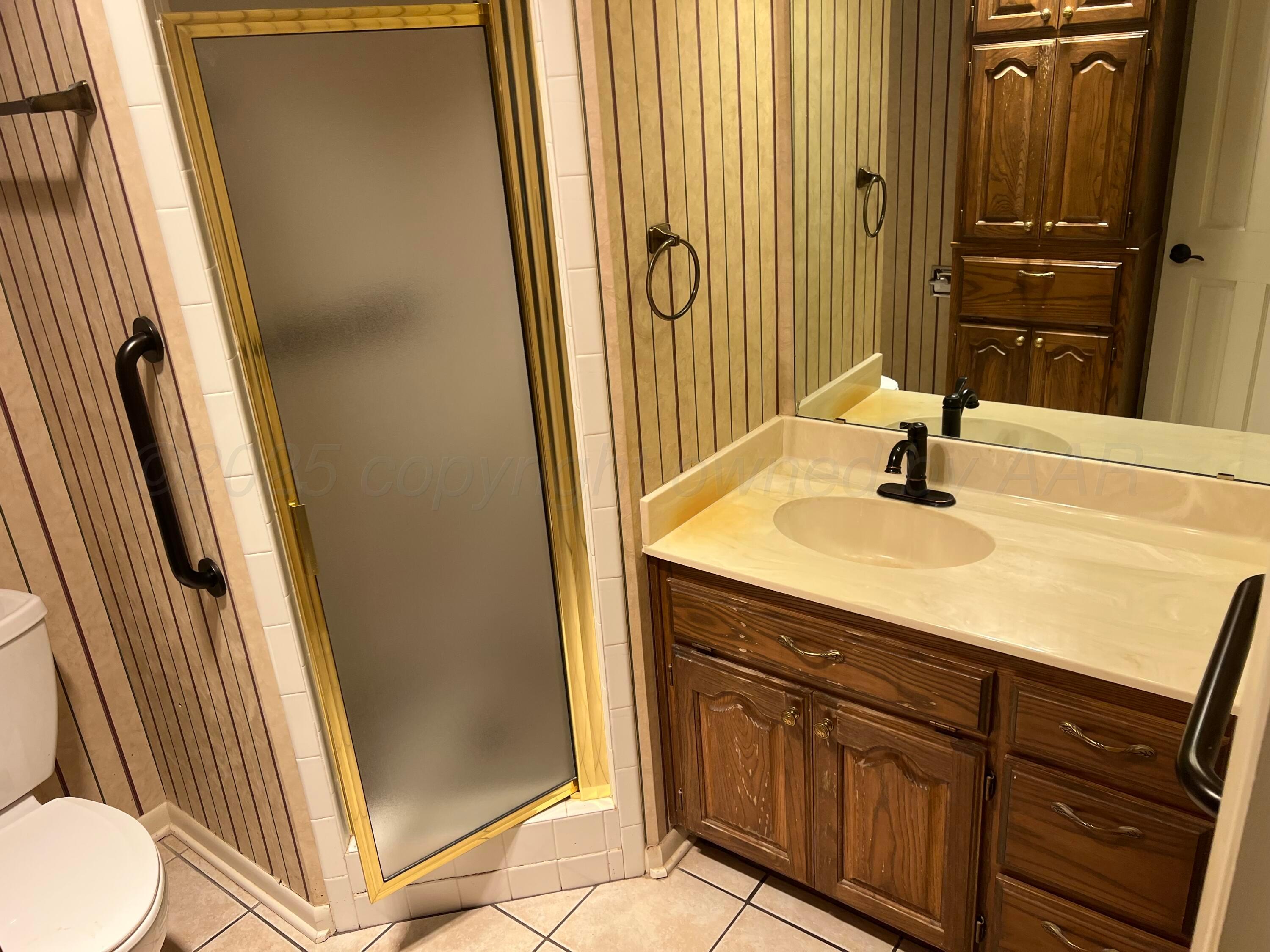 7115 Gainsborough Road Amarillo, TX 79106 - Photo 59 of 81 a bathroom with a sink a toilet and a mirror