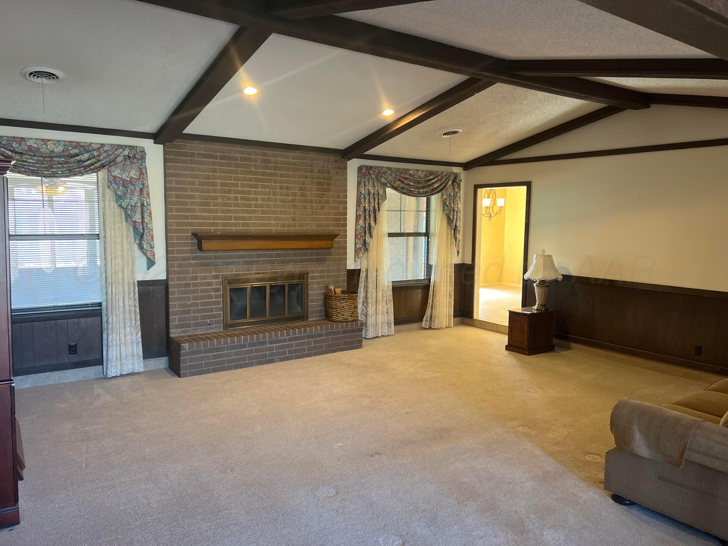 7115 Gainsborough Road Amarillo, TX 79106 - Photo 7 of 81 a big room with closet and a fireplace