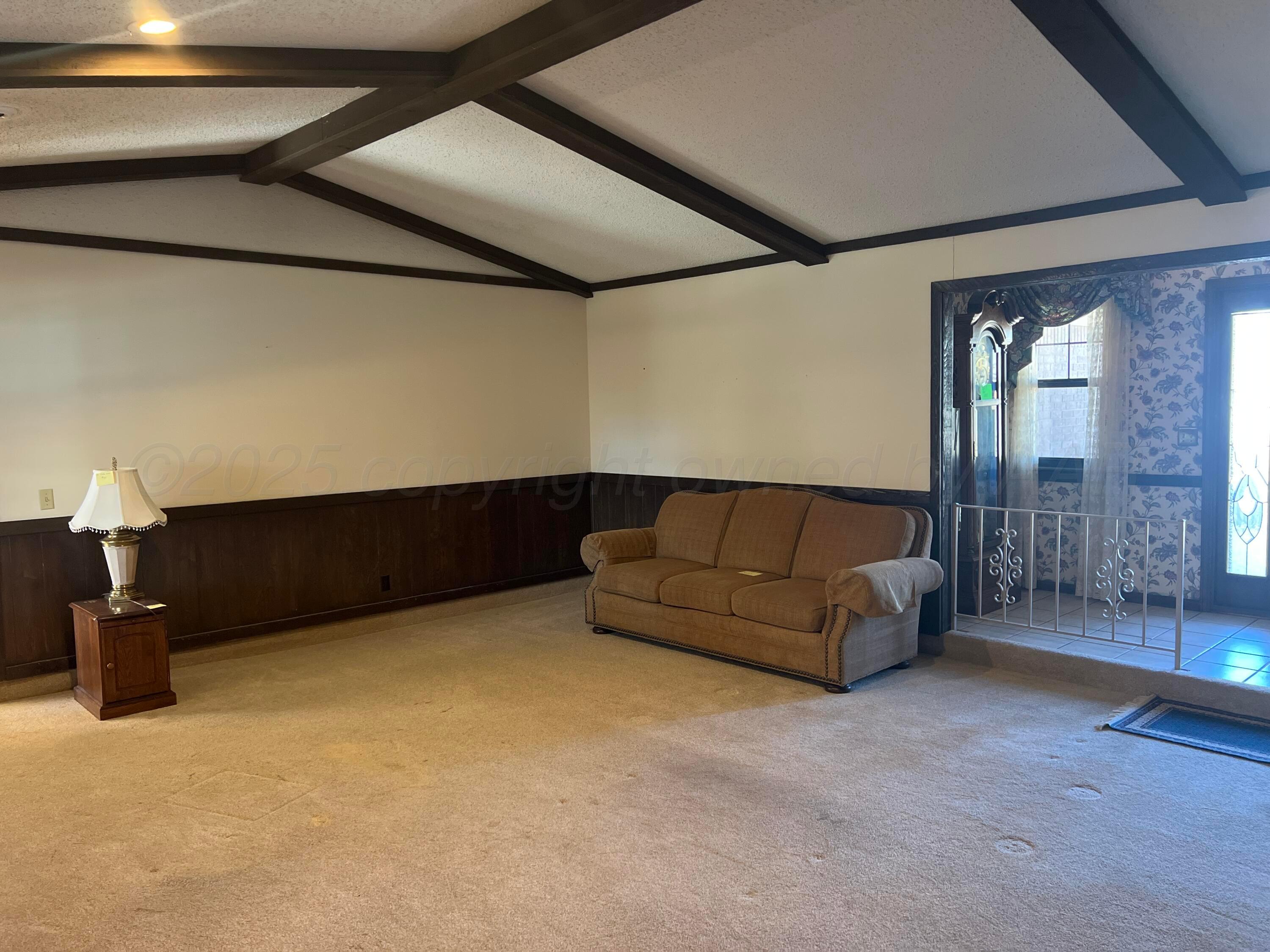 7115 Gainsborough Road Amarillo, TX 79106 - Photo 8 of 81 a living room with furniture and a flat screen tv