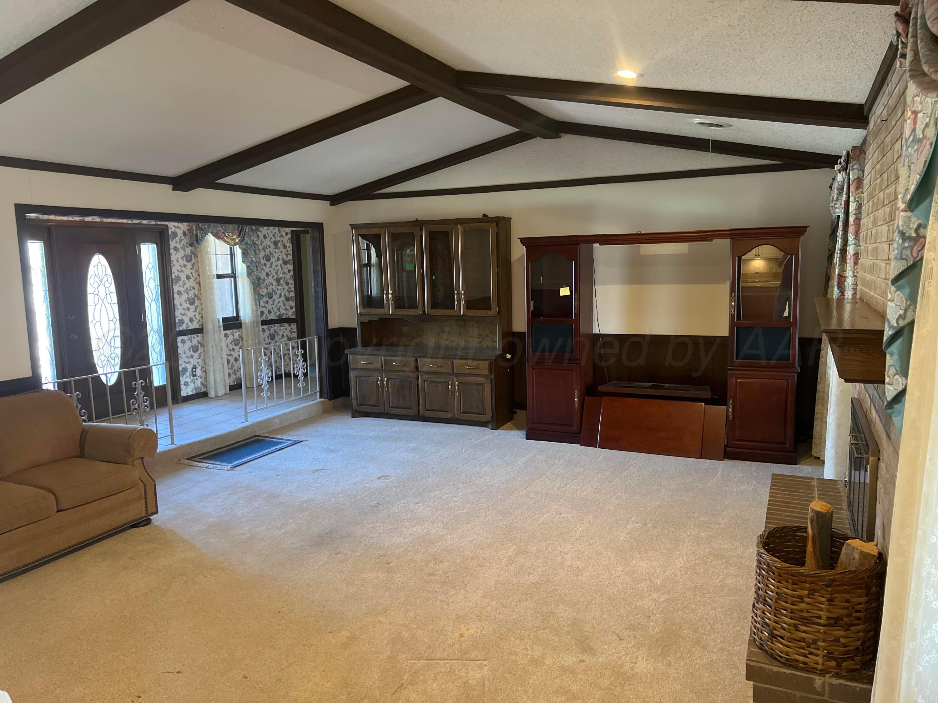 7115 Gainsborough Road Amarillo, TX 79106 - Photo 9 of 81 a living room with furniture and a flat screen tv