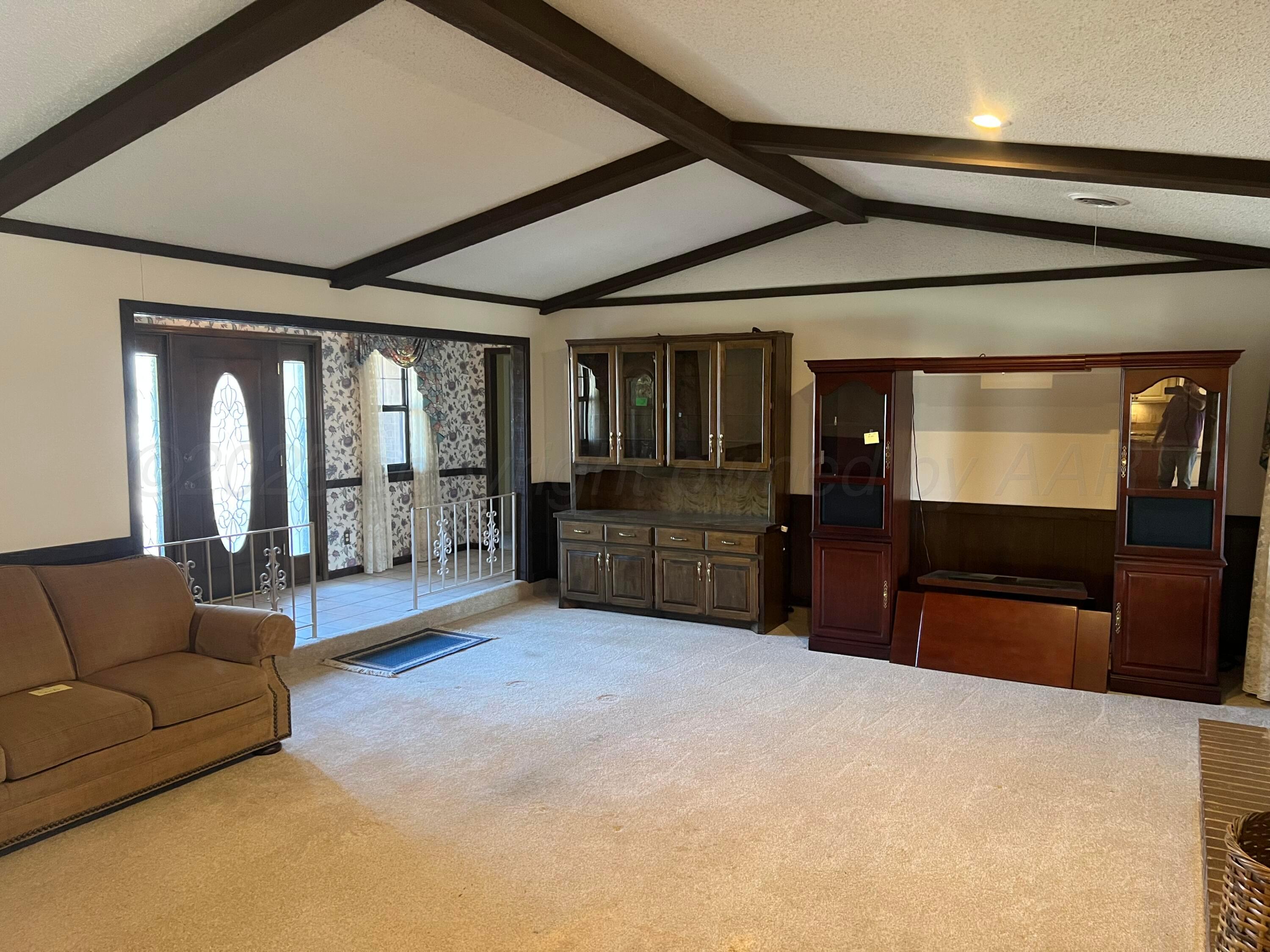 7115 Gainsborough Road Amarillo, TX 79106 - Photo 10 of 81 a living room with furniture a large window and flat screen tv