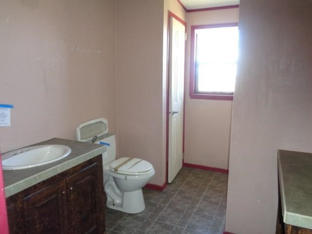 1723 Owl Road Lubbock, TX 79407 - Photo 12 of 18 a bathroom with a granite countertop toilet and sink