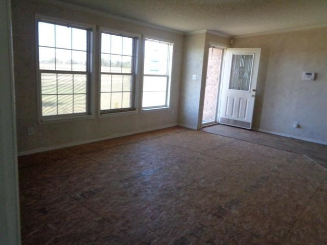 1723 Owl Road Lubbock, TX 79407 - Photo 2 of 18 an empty room with windows