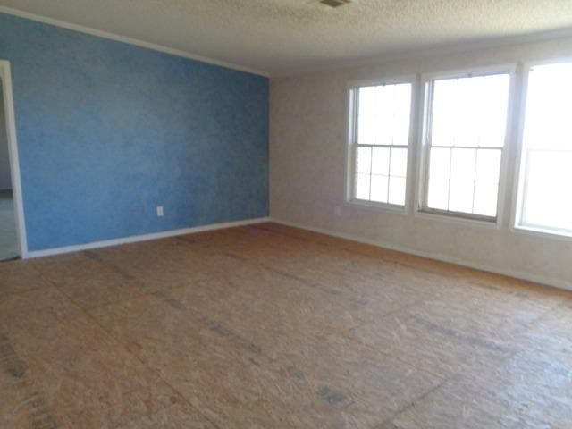 1723 Owl Road Lubbock, TX 79407 - Photo 3 of 18 an empty room with a window