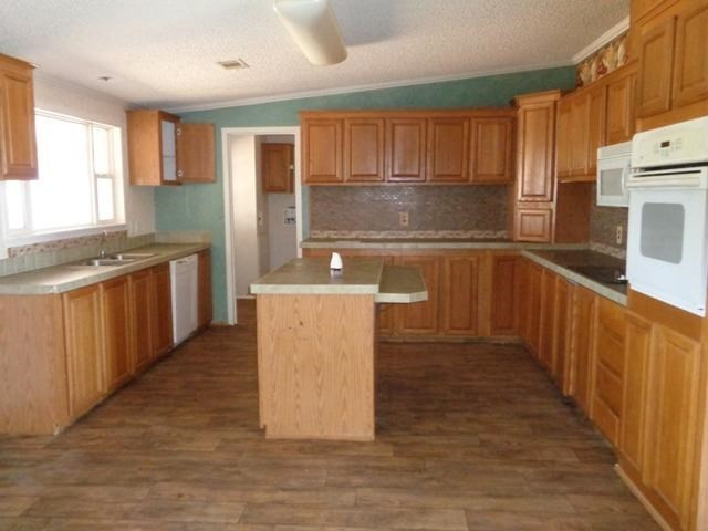 1723 Owl Road Lubbock, TX 79407 - Photo 4 of 18 a kitchen with stainless steel appliances granite countertop a refrigerator a sink and wooden cabinets