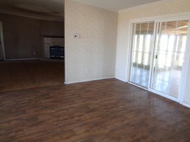 1723 Owl Road Lubbock, TX 79407 - Photo 5 of 18 a view of empty room with wooden floor