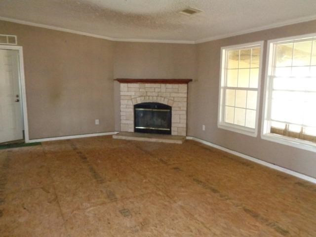 1723 Owl Road Lubbock, TX 79407 - Photo 6 of 18 an empty room with fireplace