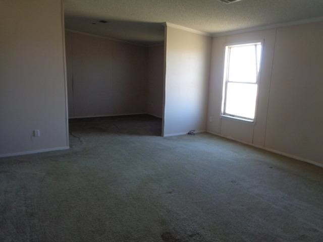 1723 Owl Road Lubbock, TX 79407 - Photo 7 of 18 an empty room with a window