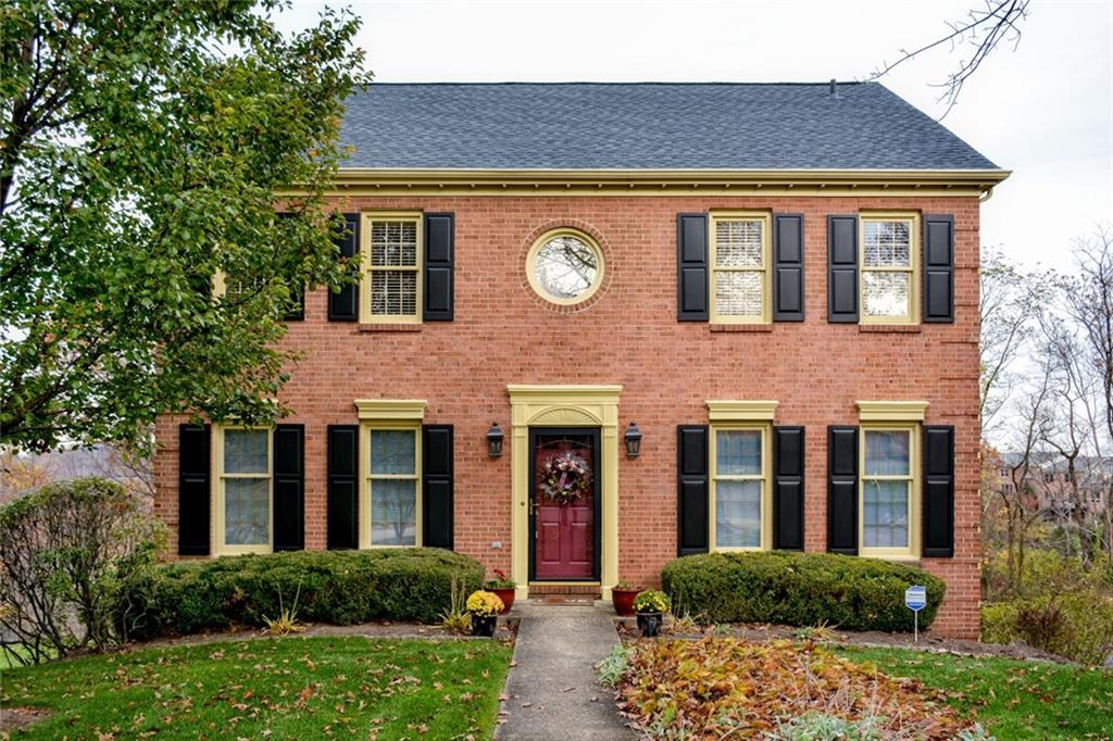 Exterior Front: Newer high-dimensional roof, gutter guards and ridge vent. Freshly painted black shutters. 