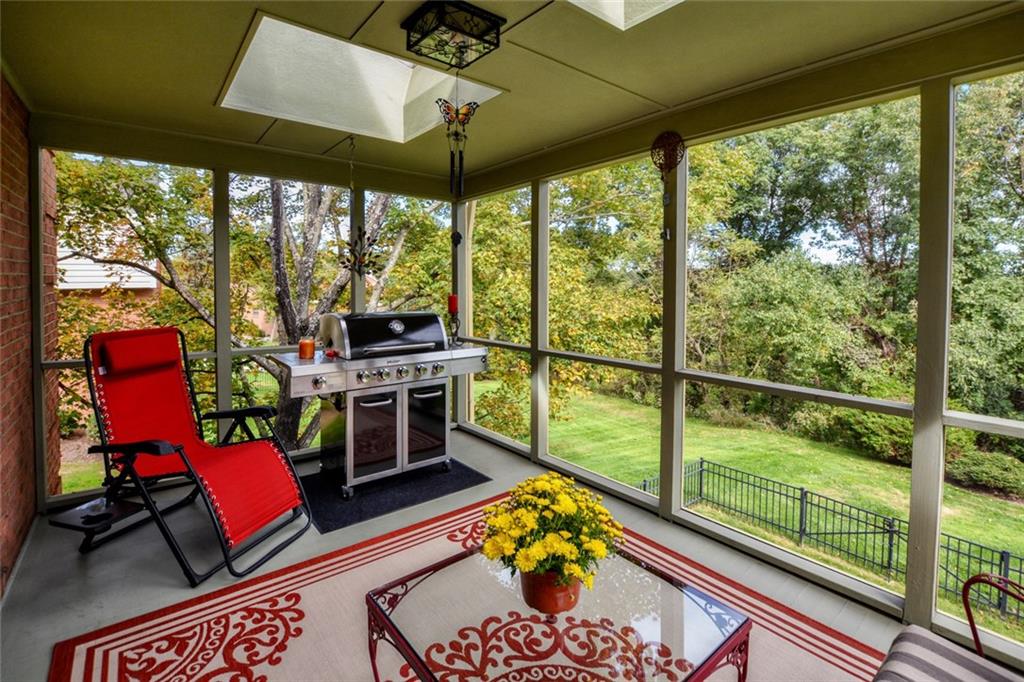 Screened Porch off family room with beautiful wooded view.