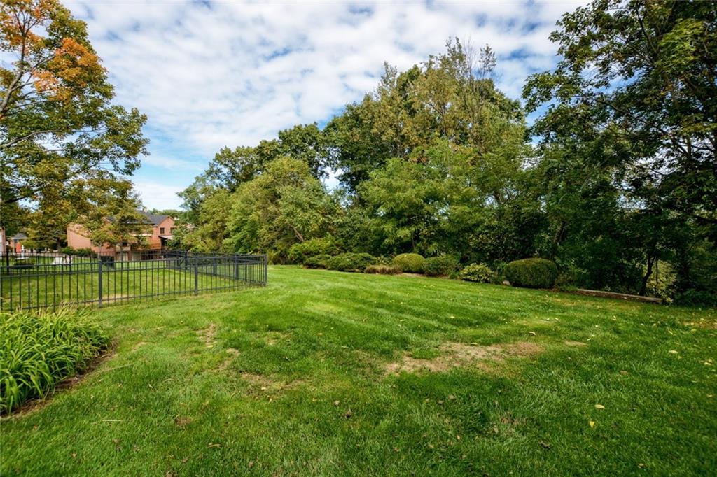 Yard and lovely treed landscaping.