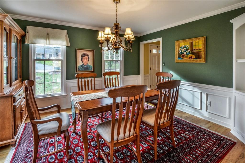 214 Sweet Gum Road Pittsburgh, PA 15238 - Photo 8 of 24 White wainscoating woodwork and corner built-in cabinets along with crown molding and rich hardwood flooring make this a great dining room for entertaining family and friends.