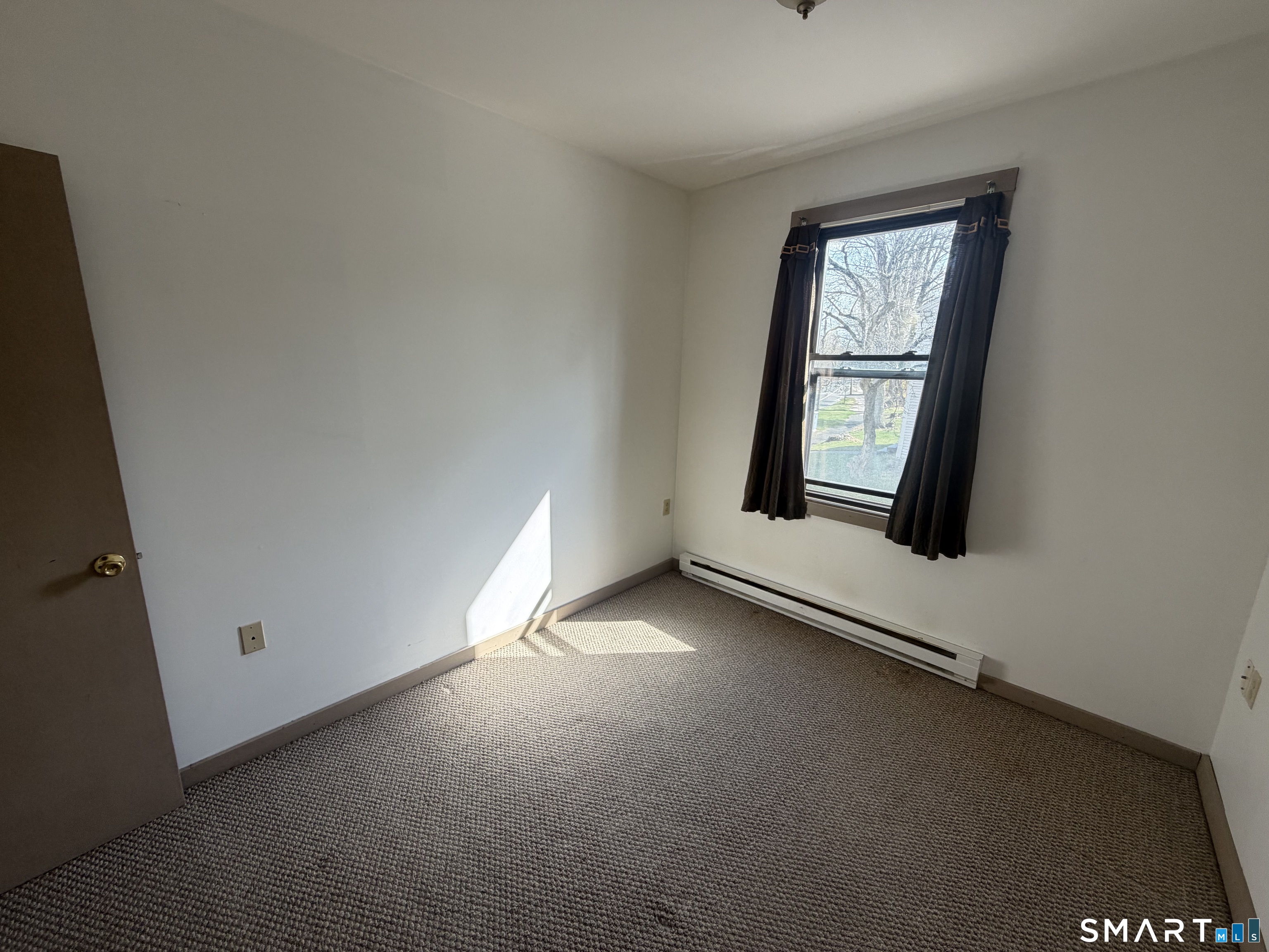 277 North Main Street, Unit 3 Winchester, CT 06098 - Photo 11 of 14 an empty room with windows