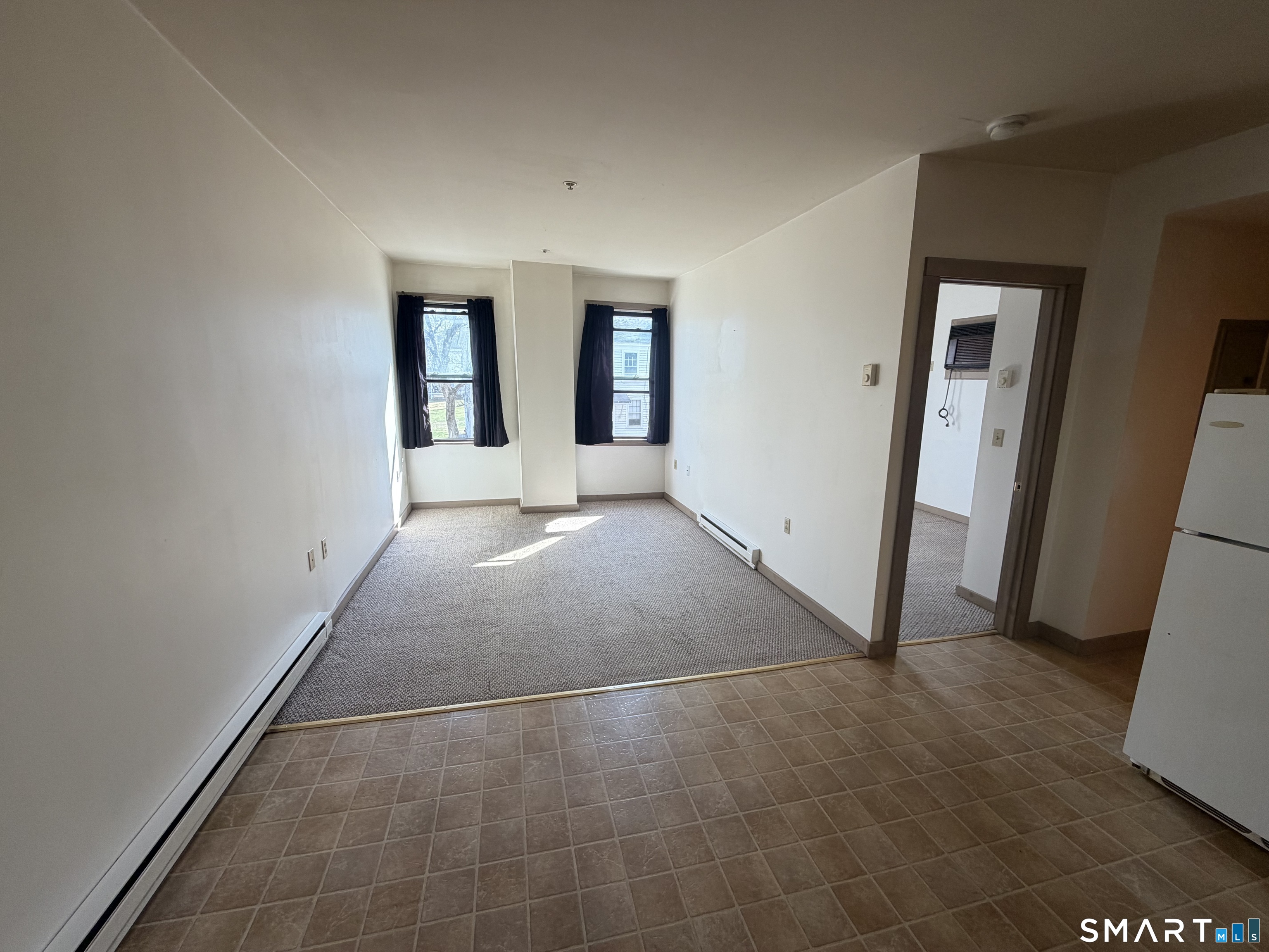 277 North Main Street, Unit 3 Winchester, CT 06098 - Photo 2 of 14 an empty room with windows
