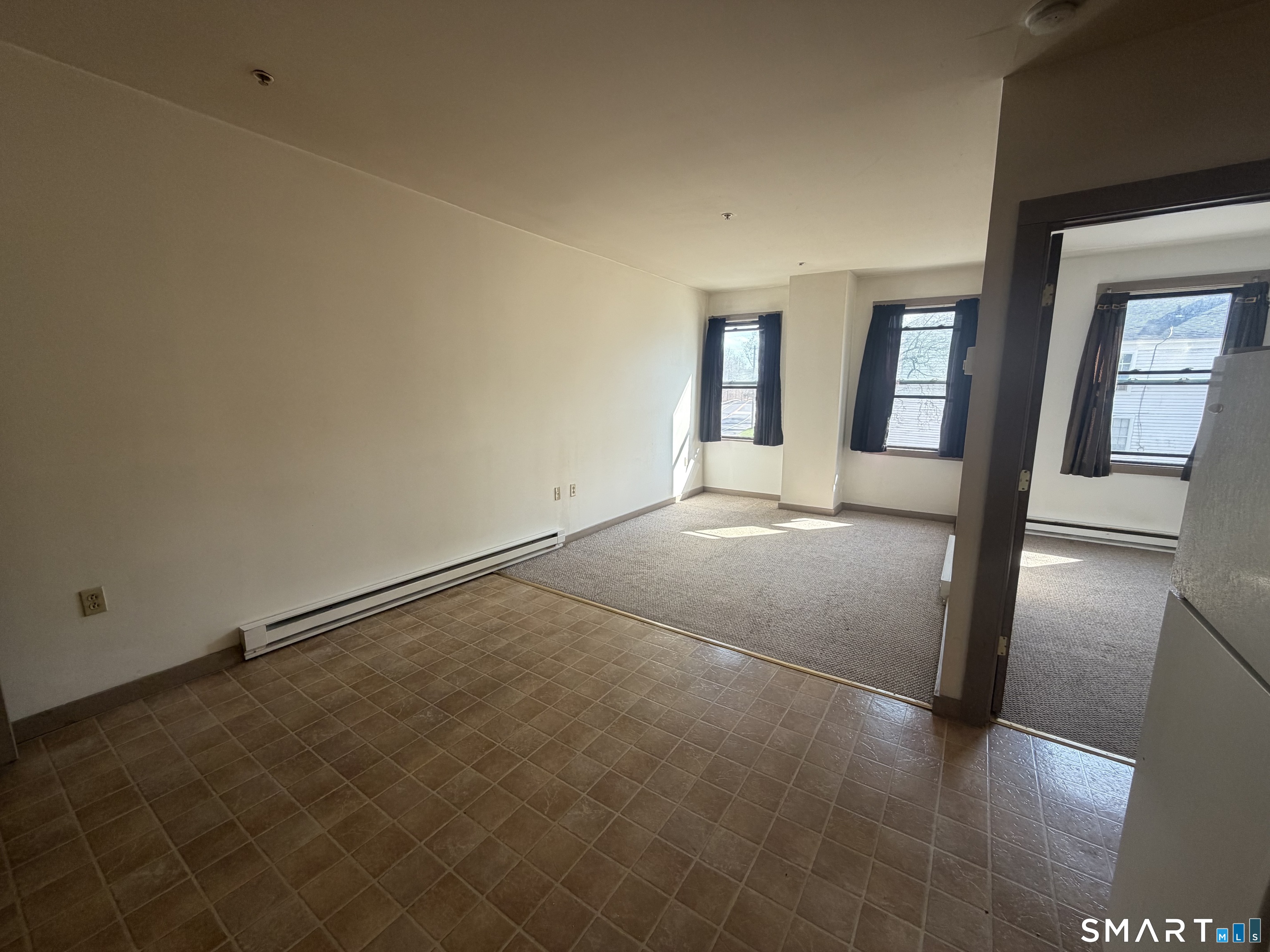 277 North Main Street, Unit 3 Winchester, CT 06098 - Photo 4 of 14 a view of an empty room with glass door