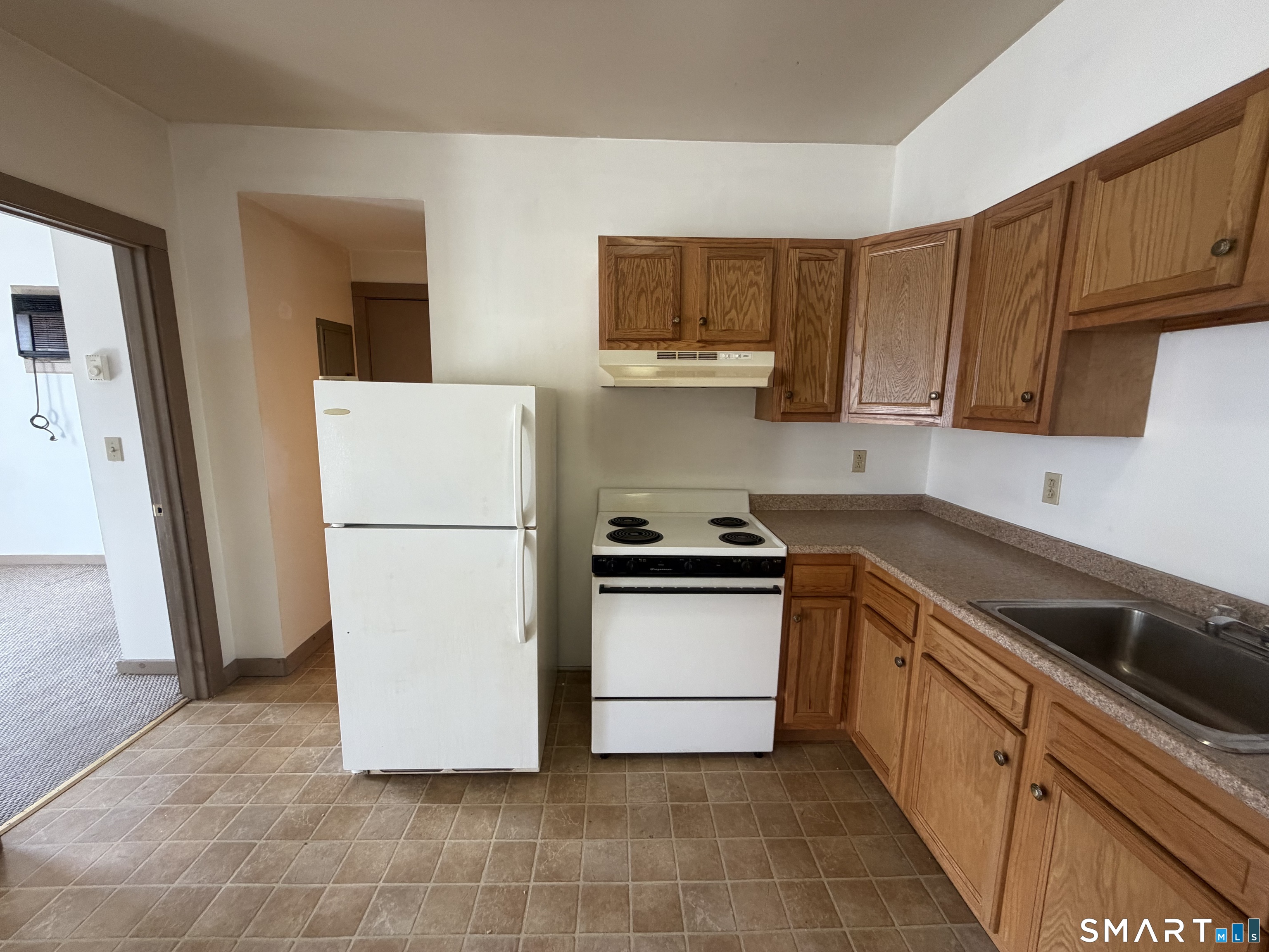 277 North Main Street, Unit 3 Winchester, CT 06098 - Photo 6 of 14 a kitchen with a sink a refrigerator and cabinets