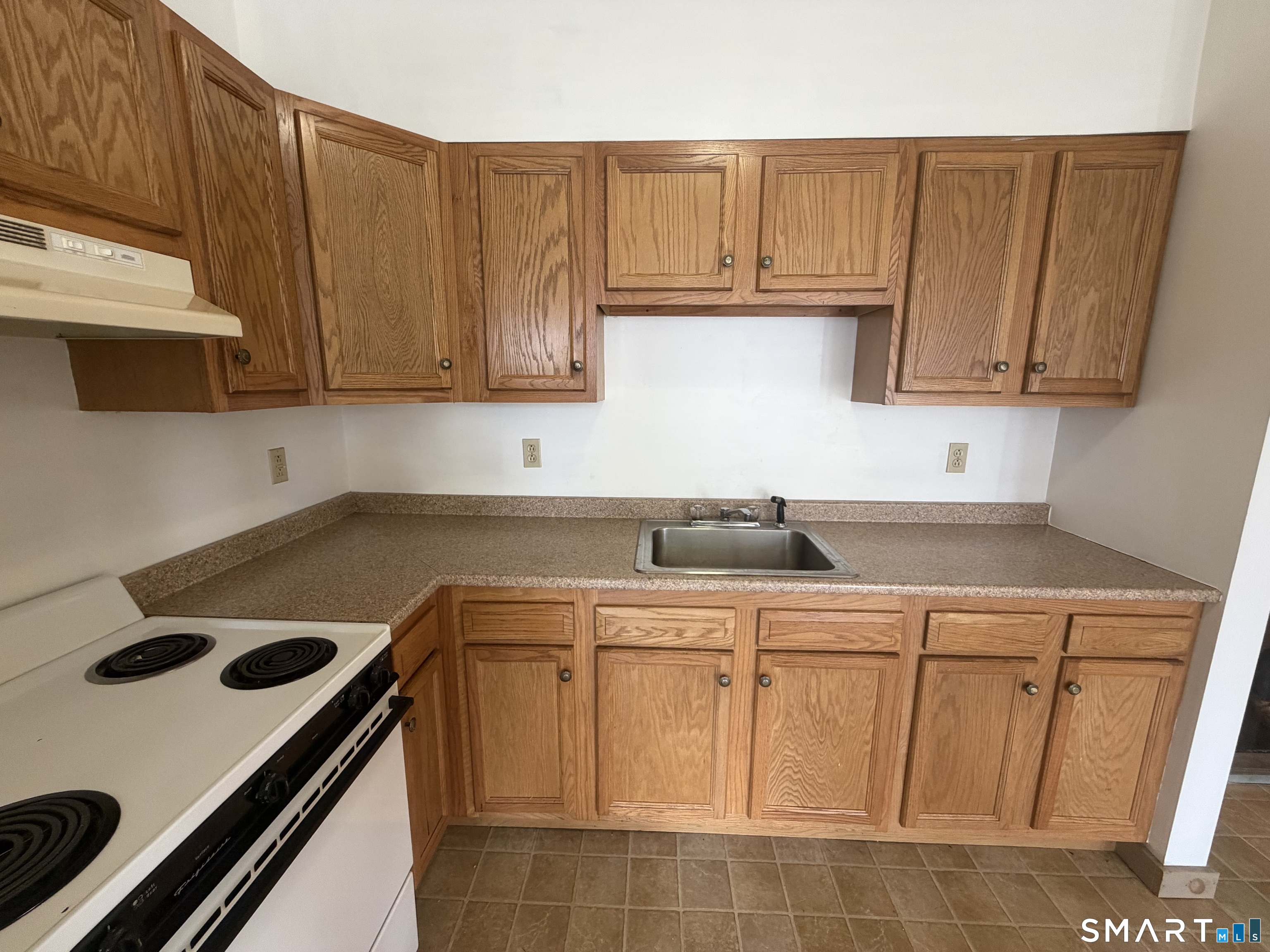 277 North Main Street, Unit 3 Winchester, CT 06098 - Photo 7 of 14 a kitchen with a sink a stove cabinets and a window