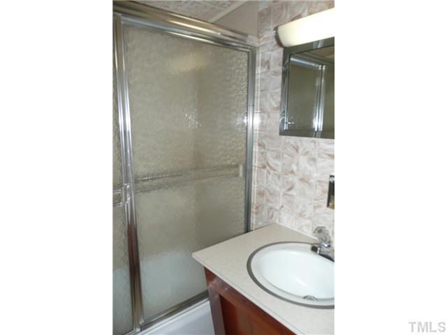 289 Chambers Loop Road Timberlake, NC 27583 - Photo 15 of 20 a bathroom with a sink toilet and shower