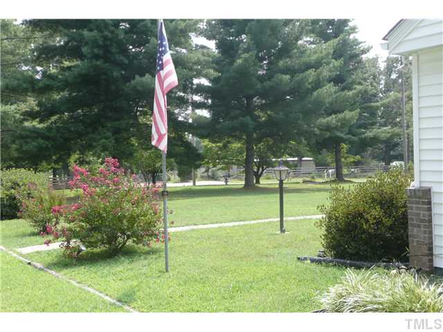 289 Chambers Loop Road Timberlake, NC 27583 - Photo 3 of 20 a backyard of a house with lots of green space