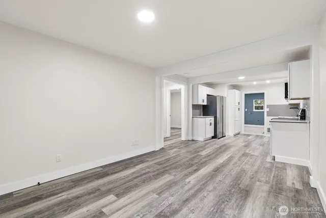 a view of a kitchen with a sink and a refrigerator