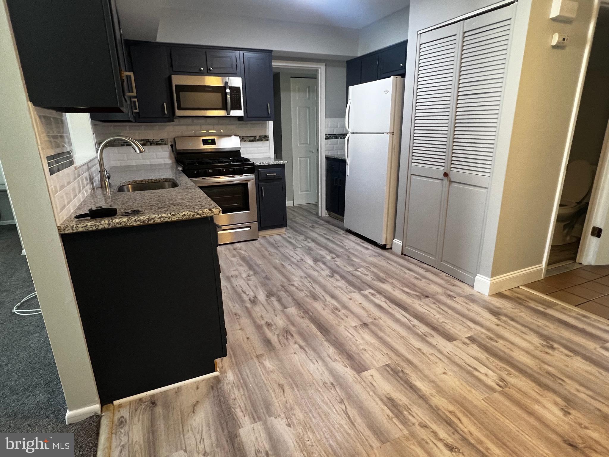 1756 Hybrid Place Clementon, NJ 08021 - Photo 6 of 13 a kitchen with a refrigerator and a stove