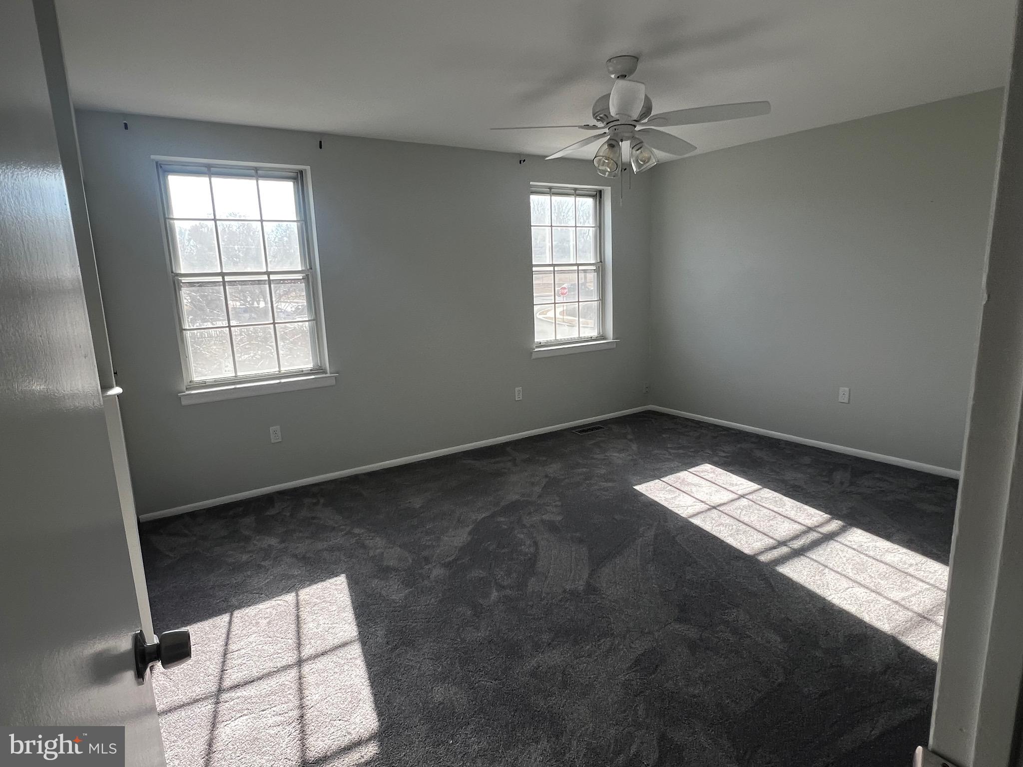 1756 Hybrid Place Clementon, NJ 08021 - Photo 7 of 13 an empty room with windows and ceiling fan