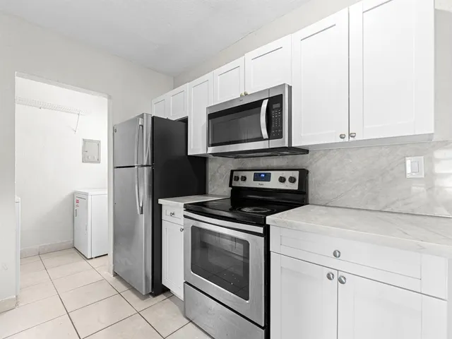a kitchen with a stove microwave and refrigerator