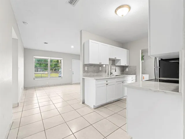 a kitchen with a stove a sink and a refrigerator