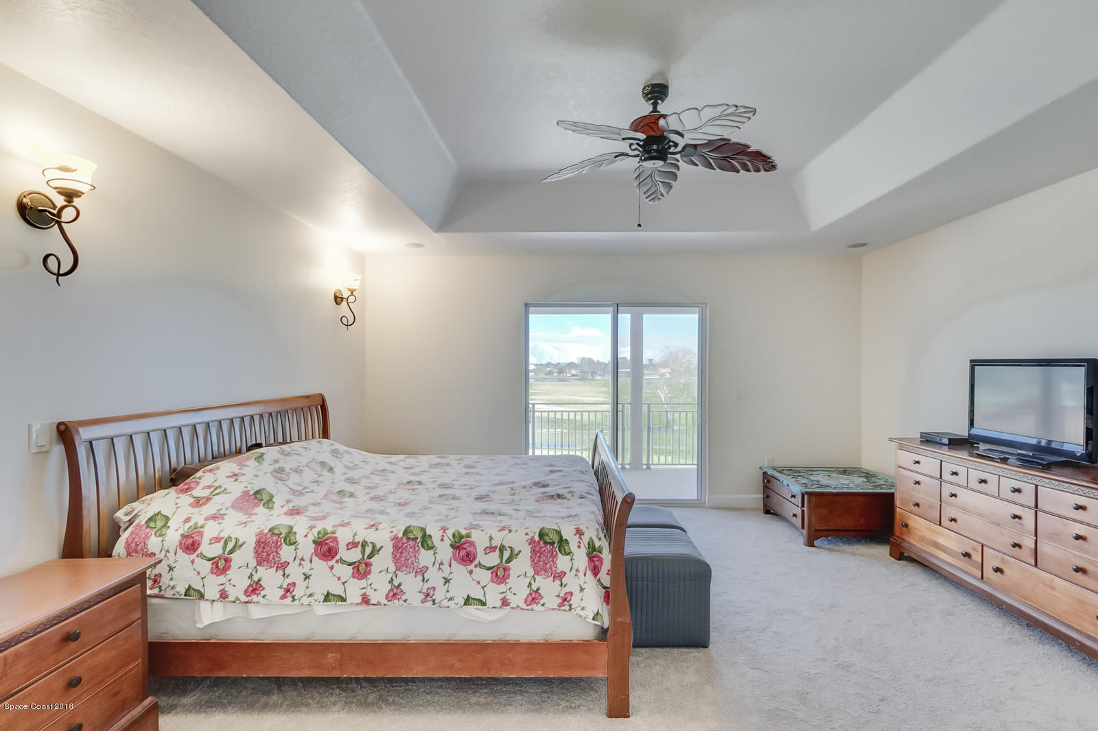 42 Country Club Road Cocoa Beach, FL 32931 - Photo 22 of 26 a bedroom with a bed and a chandelier