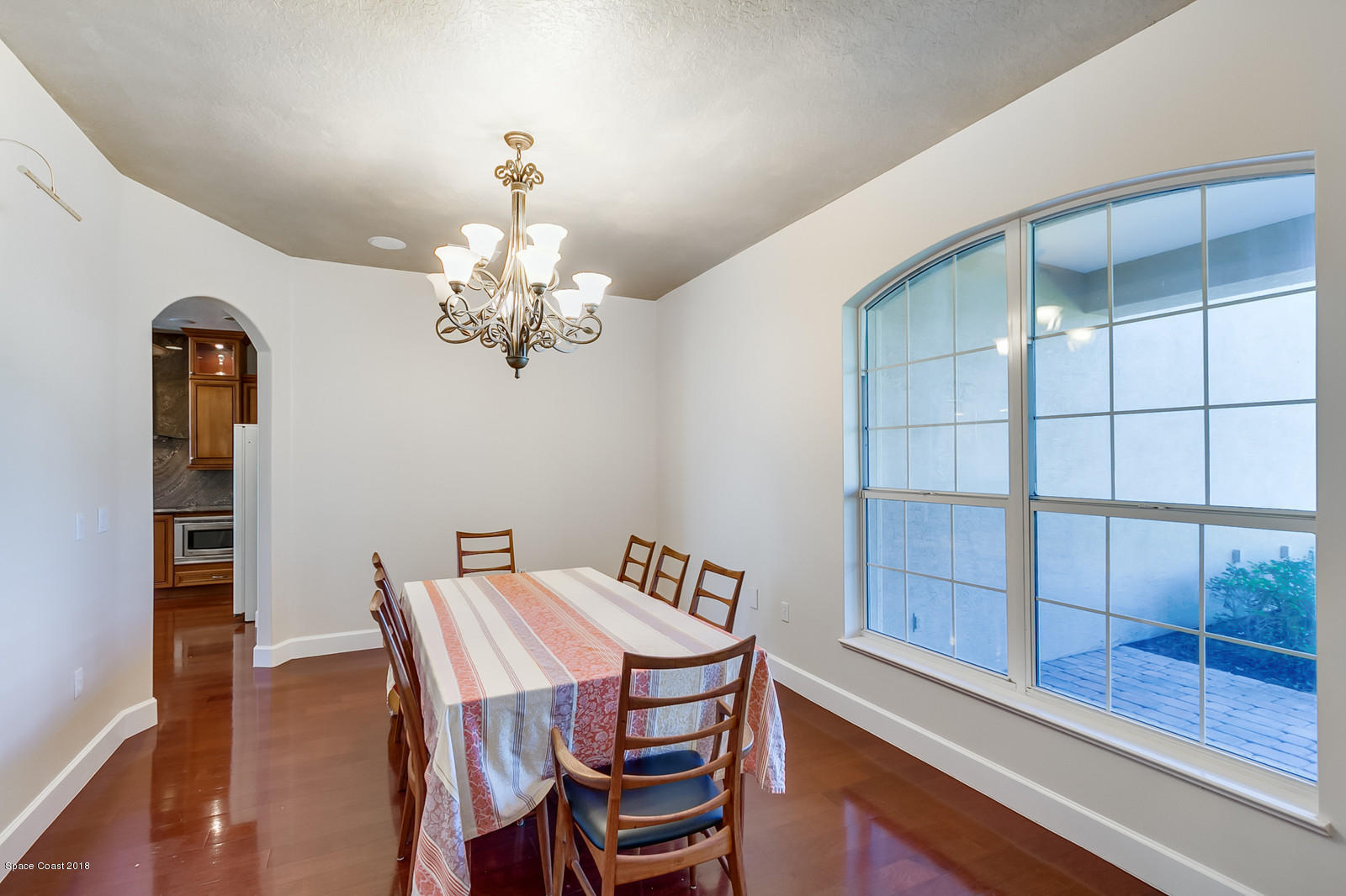 42 Country Club Road Cocoa Beach, FL 32931 - Photo 5 of 26 a view of a dining room with furniture and chandelier