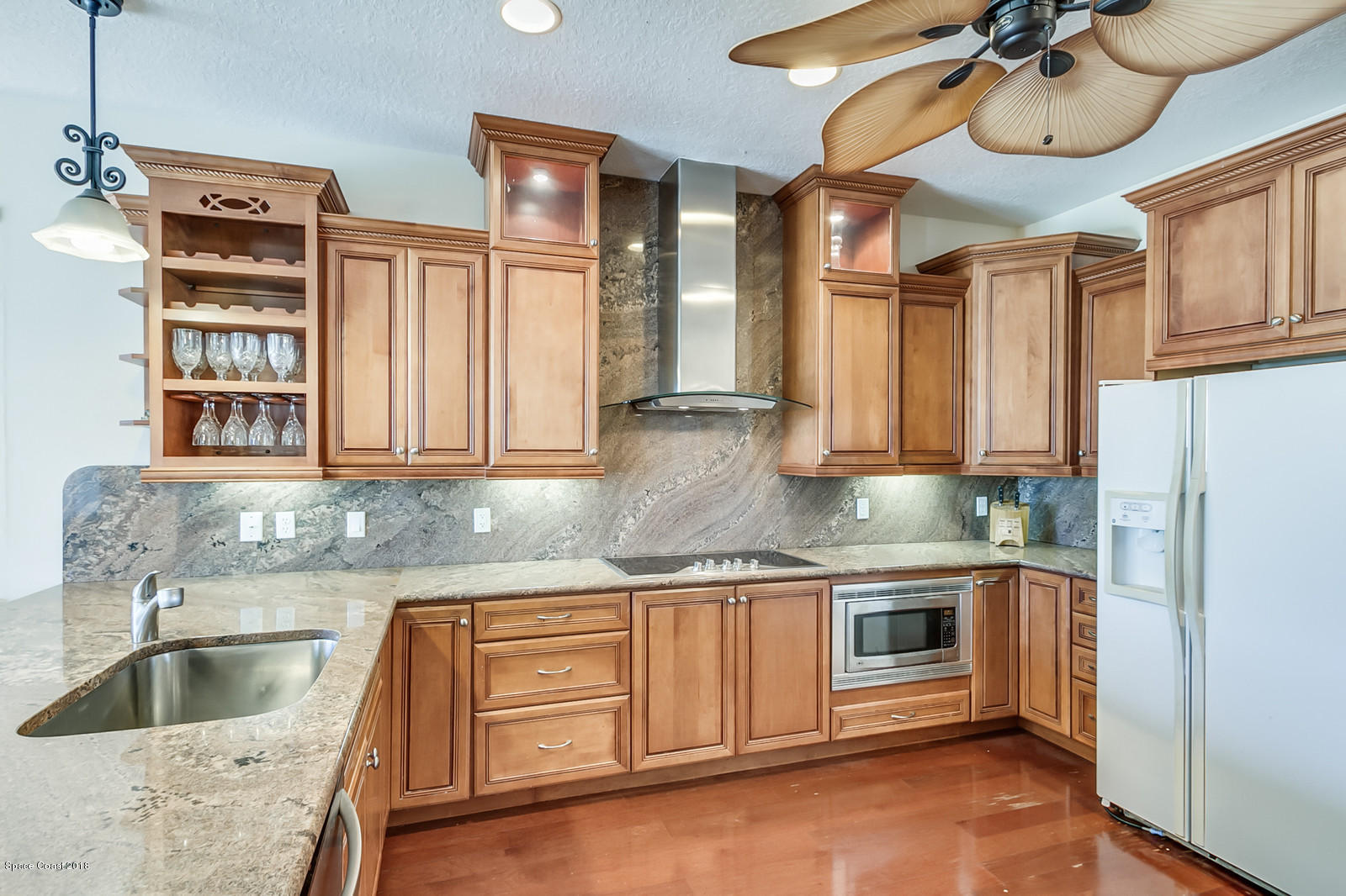 42 Country Club Road Cocoa Beach, FL 32931 - Photo 8 of 26 a kitchen with stainless steel appliances granite countertop a sink a stove and cabinets