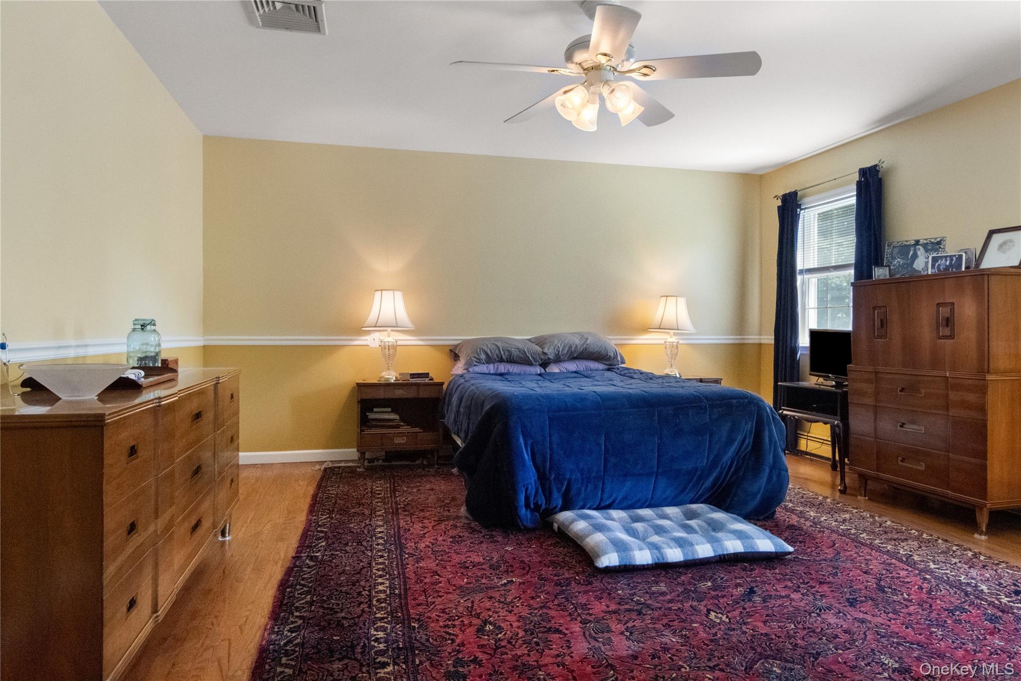 214 West Mombasha Road Monroe, NY 10950 - Photo 21 of 43 a bedroom with a bed and wooden floor