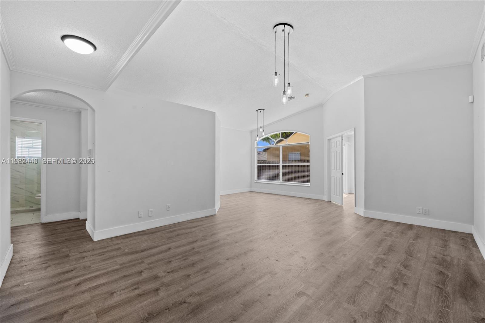 8050 Southwest 157th Place Miami, FL 33193 - Photo 3 of 12 wooden floor in an empty room with a window