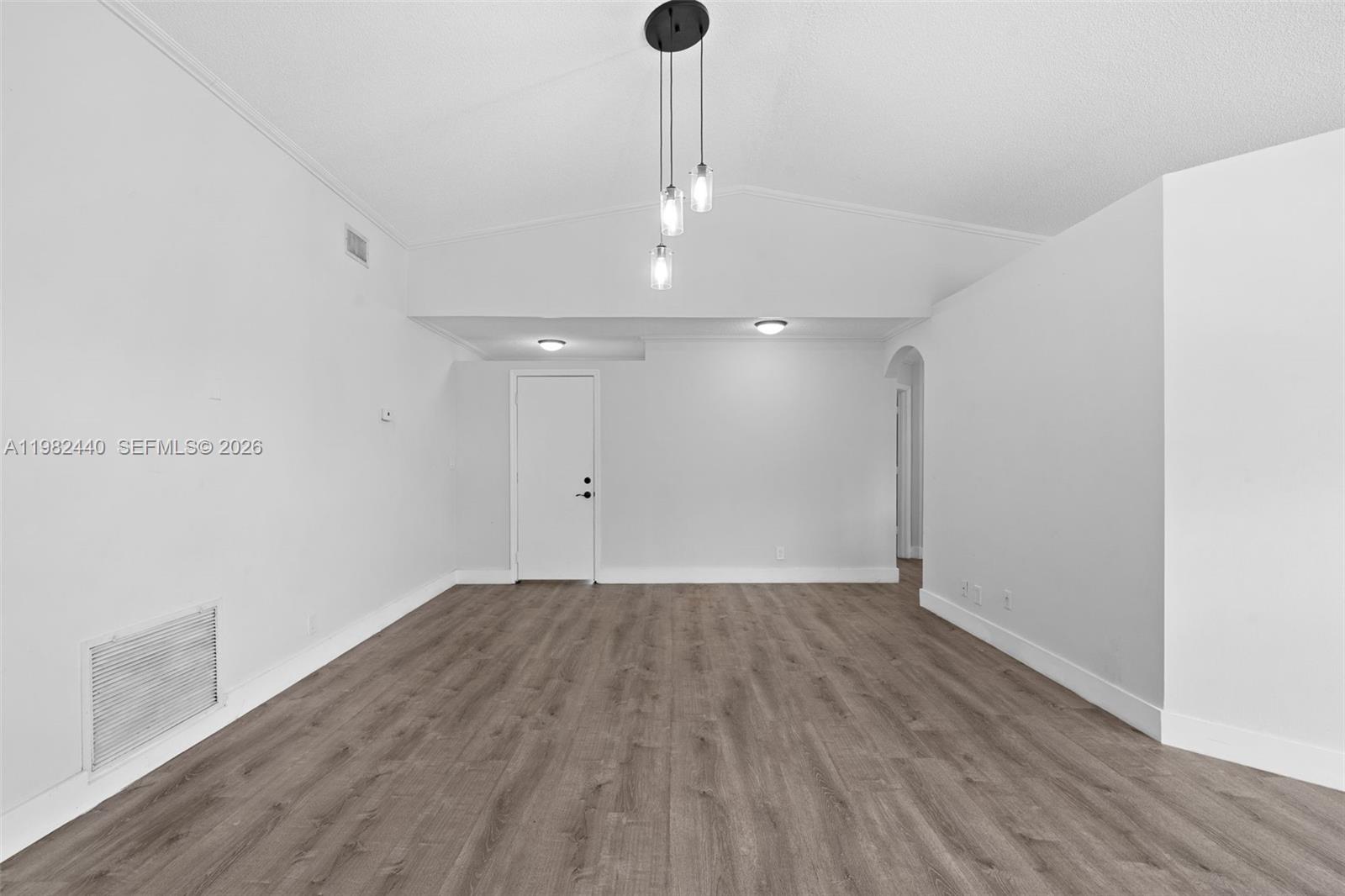 8050 Southwest 157th Place Miami, FL 33193 - Photo 5 of 12 a view of an empty room with wooden floor and a window