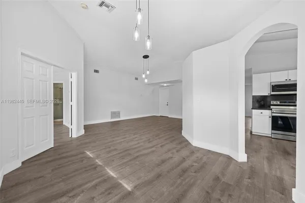 a view of a kitchen with wooden floor