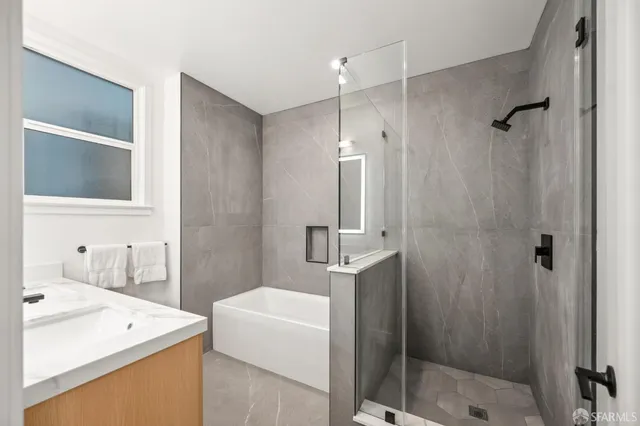 a bathroom with a sink a shower and a mirror