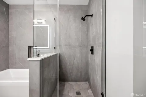 a bathroom with a sink a mirror a shower and vanity