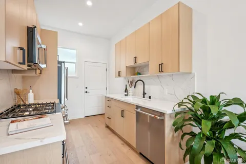 a kitchen with a white stove top oven and white cabinets