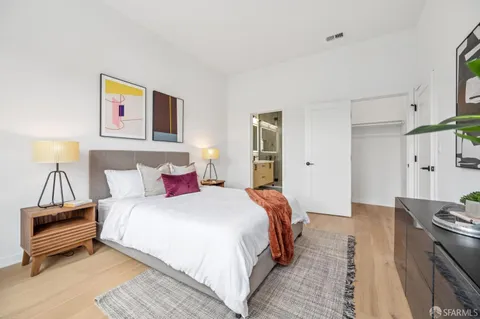 a bedroom with a bed and a couch