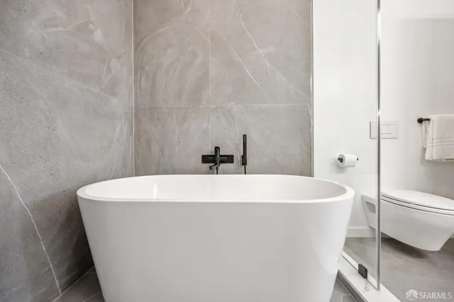 a white bath tub sitting in a bathroom