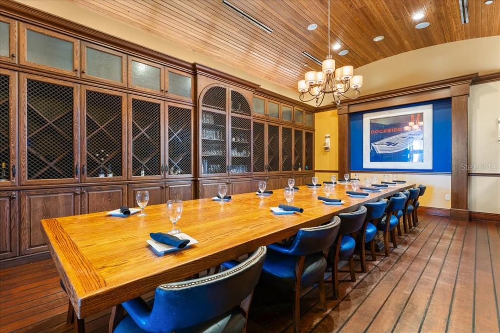 102 Riviera Dunes Way, Unit C22 Palmetto, FL 34221 - Photo 16 of 23 a view of a dining room with furniture a chandelier and wooden floor