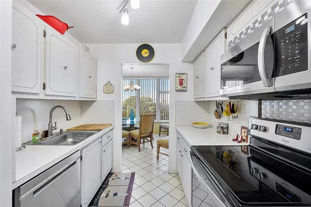 a bathroom with a granite countertop sink a mirror and a shower