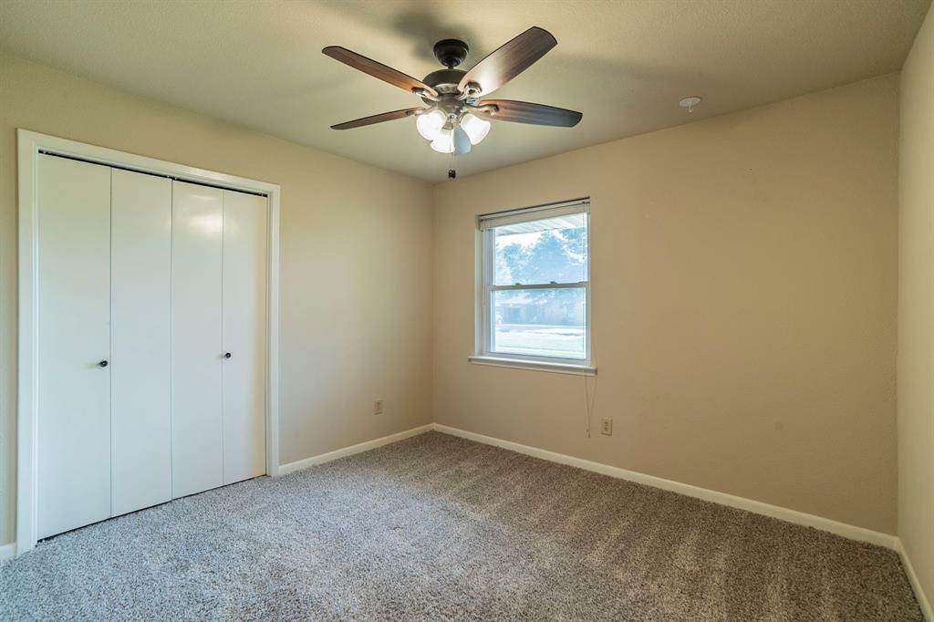 705 South 4th Street Midlothian, TX 76065 - Photo 11 of 15 an empty room with a ceiling fan and window