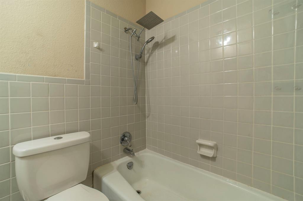 705 South 4th Street Midlothian, TX 76065 - Photo 13 of 15 a bathroom with a toilet and shower